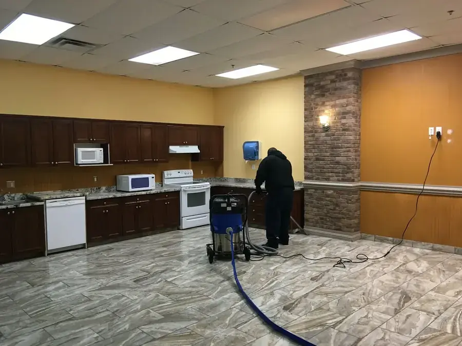 Technician extracting standing water from a floor in an Inglewood, CA home